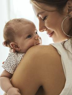 Beautiful mother kissing here little cute baby