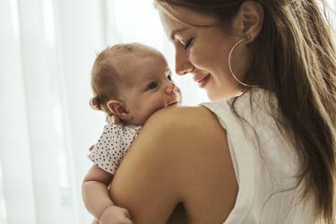 Beautiful mother kissing here little cute baby